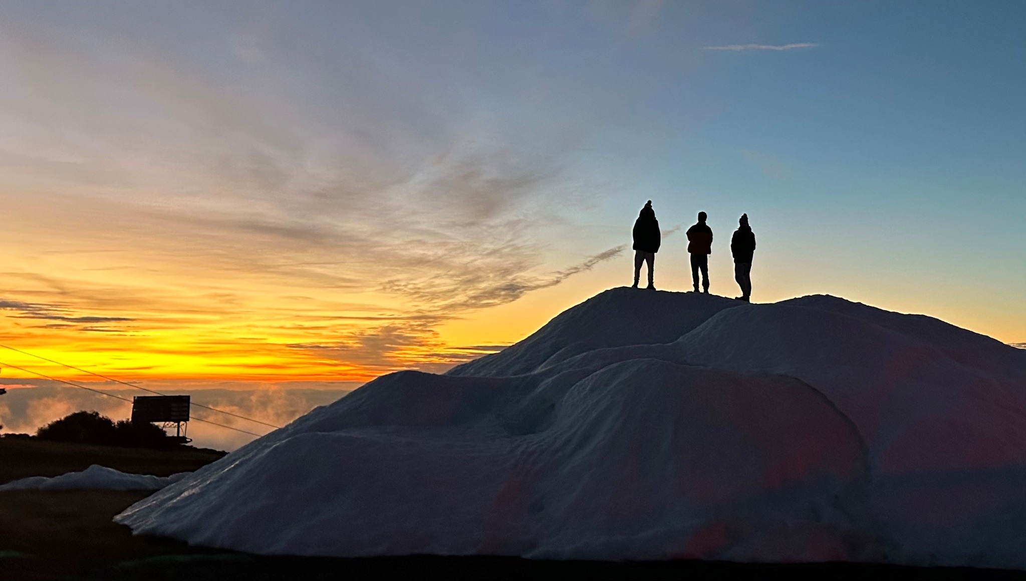 Large stockpile of snow made by Mt Buller's Snow Factories in May at sunset