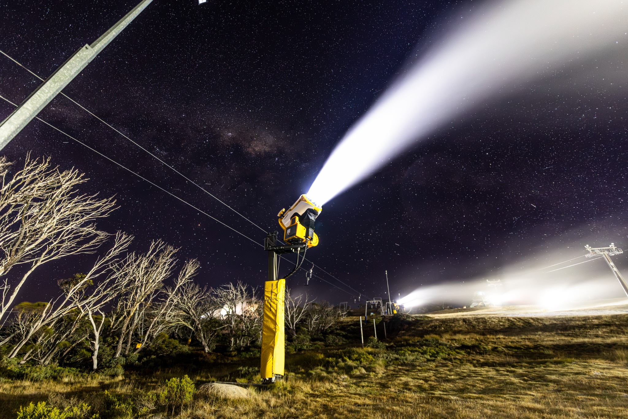 A snowgun operating at night at Perisher under a star-filled sky
